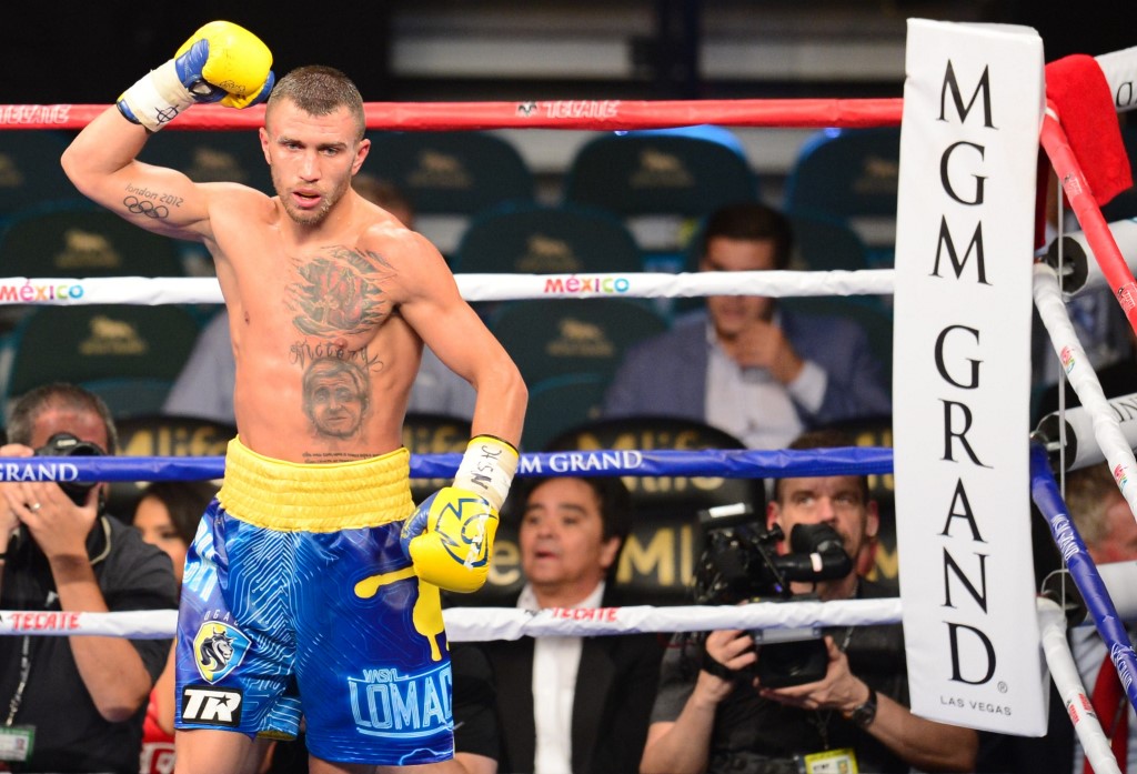 World featherweight boxing champion Vasyl Lomachenko of Ukraine celebrates his ninth round knockout victory over Gamalier Rodriguez of Puerto Rico  on May 2, 2015 at the MGM Grand Garden Arena in Las Vegas, Nevada. AFP PHOTO / FREDERIC J. BROWN (Photo by FREDERIC J. BROWN / AFP)
